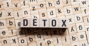 - Visalia Recovery Center Wooden letter tiles spell DETOX on a background of scattered alphabet blocks; concept image about detoxing.